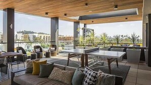 A modern outdoor seating area with a view of the city.