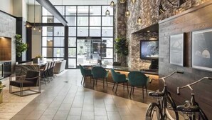 A modern interior with a large open space, seating area, and a bike.