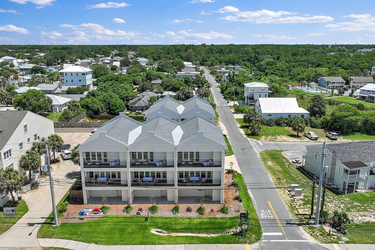 A multi-story hotel with a central courtyard, surrounded by a residential neighborhood.