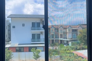A multi-story building with balconies and a garden area. - Field Time Homestay (Yilan)