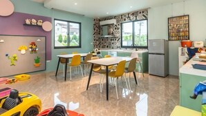 A modern kitchen with a dining area, large windows, and a children's play area. - Field Time Homestay (Yilan)