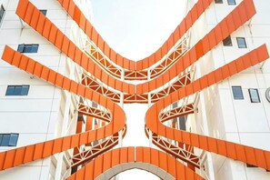A building with a distinctive spiral staircase design, multiple floors, and a symmetrical facade. - JI Hotel (Xiamen Airport Huli Avenue) (Xiamen)