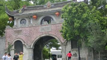An archway with traditional architecture, including a tiled roof and decorative elements.