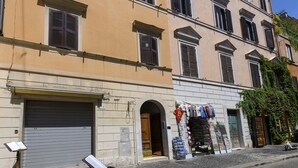 A multi-story building with a ground-floor shop displaying various items. - Bernini al Borgo - St Peter Vatican (Rome)