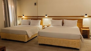 Two double beds with wooden headboards and bedside tables, each with a lamp. - Amakuza Residence (Kigali)