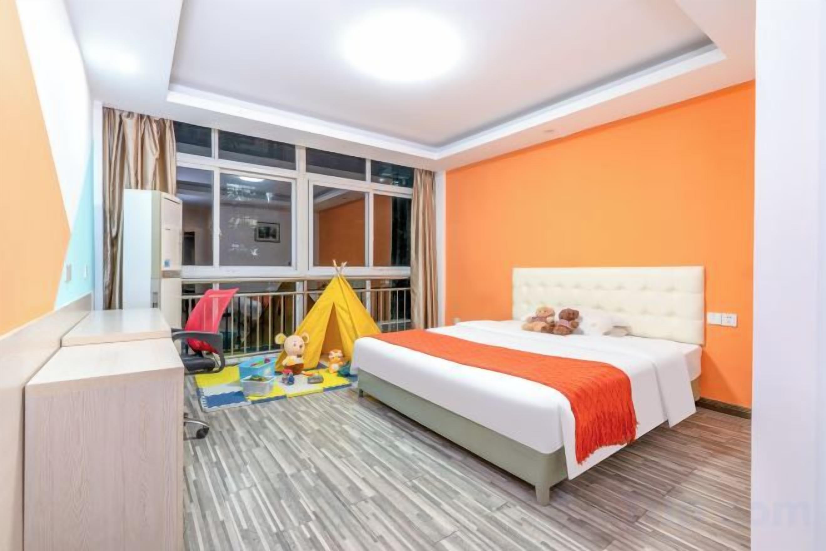Een hotelkamer met een bed, een raam, een tent en een bureau.