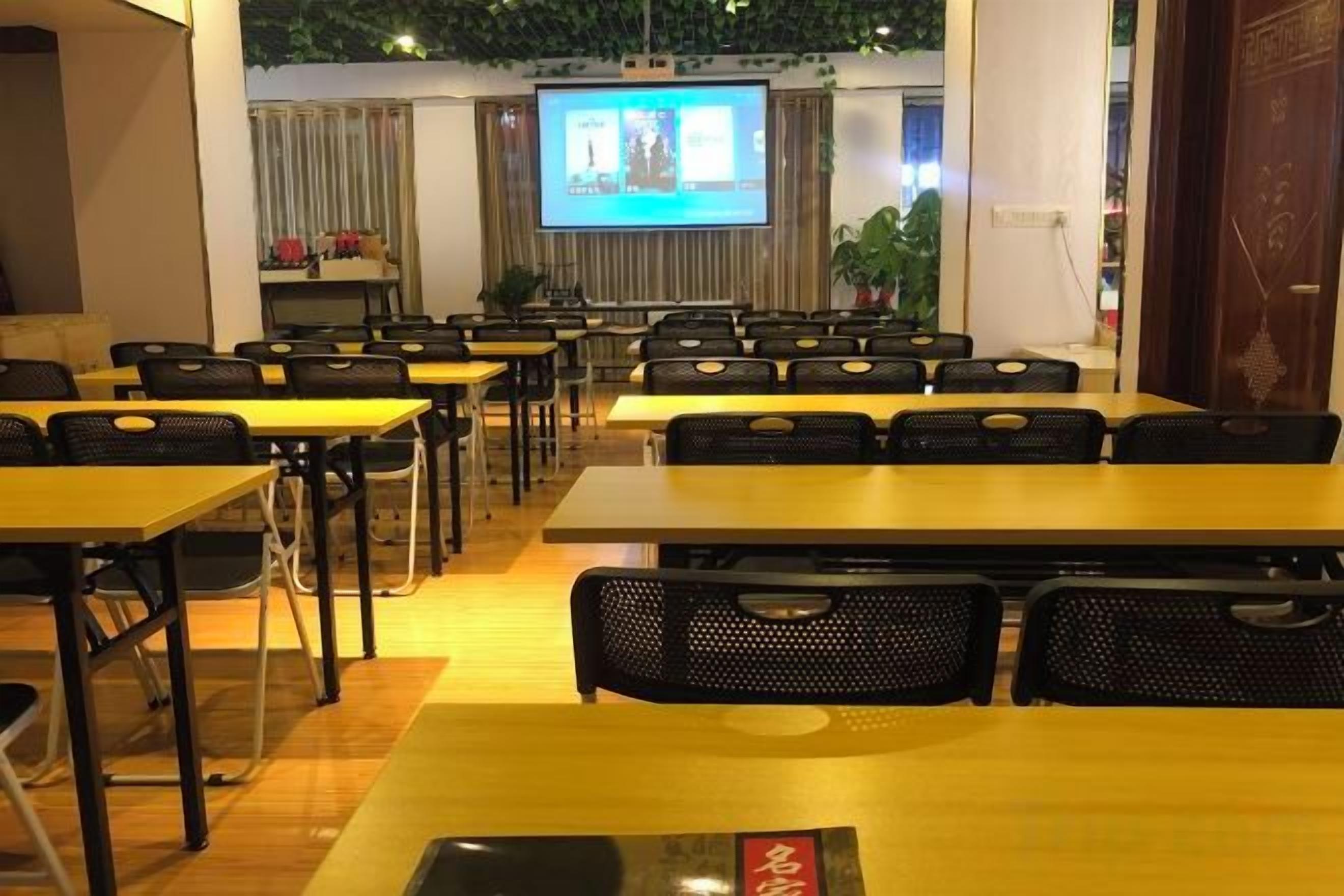 A conference room with tables and chairs arranged for a meeting.