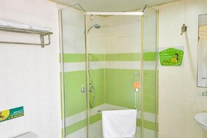 A bathroom with a glass shower enclosure, a white sink, and a green and white striped wall. - Meishang Hotel (Wuhan)