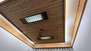 A ceiling with wooden slats and two skylights. - Jingxutang Hostel (Wuyuan)