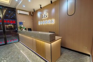 A hotel reception desk with a wooden finish and a digital screen. - Guilin City Express Hotel (Guilin)