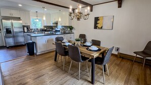 A modern kitchen with a dining area, stainless steel appliances, and a chandelier. - Elegant 4BR Princeton Escape • Game Rm • Big Yard (Princeton)