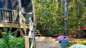 A wooden deck leading to a cabin with a 'Please Watch Your Step' sign. - Falcons Nest cabin with AC and WiFi in enchanting Calhoun TN (Calhoun)