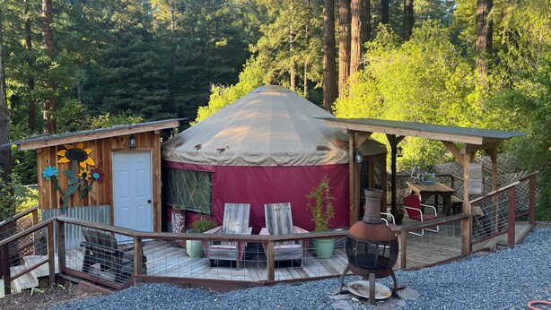 A rustic wooden cabin with a yurt, a deck, and a grill area. - Whimsical Wilderness: Wonderful Yurt Stay (Guerneville)