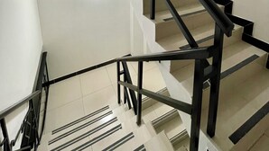 A modern staircase with black railings and white walls. - Hotel Embajada 44 (Bogotá)