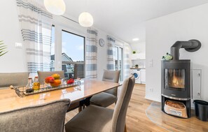 Enjoy meals in the central dining area with a stove and comfortable seating.