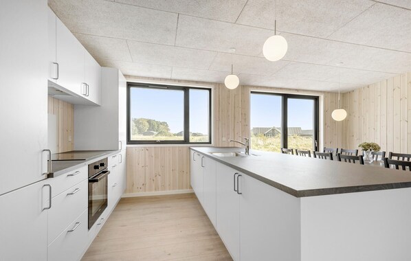 Fridge, stovetop, dishwasher, coffee/tea maker