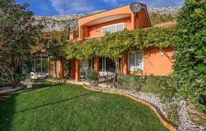 A modern house with a curved roof, a satellite dish, and a well-maintained garden. - Cozy home in Klis with WiFi (Klis)