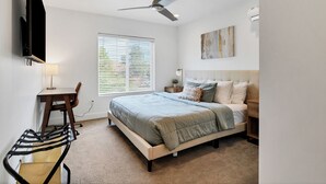 A bedroom with a bed, a desk, a chair, a ceiling fan, and a window with blinds. - Newly furnished 5bd/4.5ba Townhome - The Vue 30 welcomes you! (St. George)