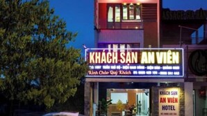 A hotel with a prominent sign reading 'KHACH SAN AN VIEN HOTEL' and a car parked in front. - An Vien Hotel (Da Nang)
