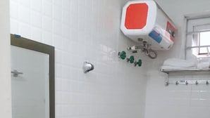 A small, compact bathroom with a white sink, a toilet, and a shower. - Hoang Hiep Hotel Sapa - by Bay Luxury (Sa Pa)