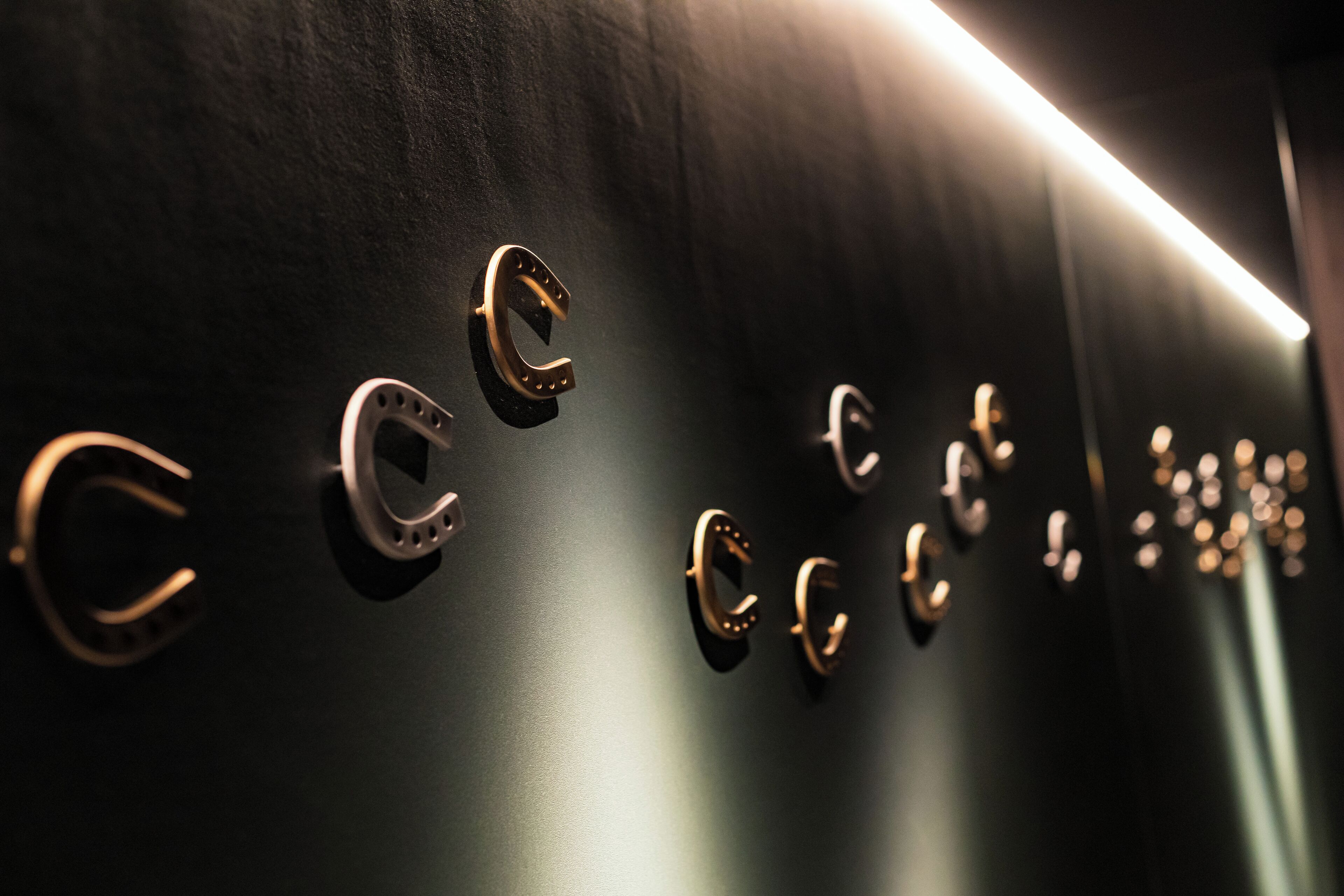 A wall with multiple circular metallic handles.