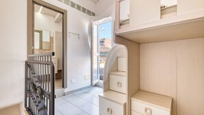 A modern, well-lit hallway with a staircase, a wooden wardrobe, and a mirror. - Sea Stone - 100m From The Sea (Borghetto Santo Spirito)