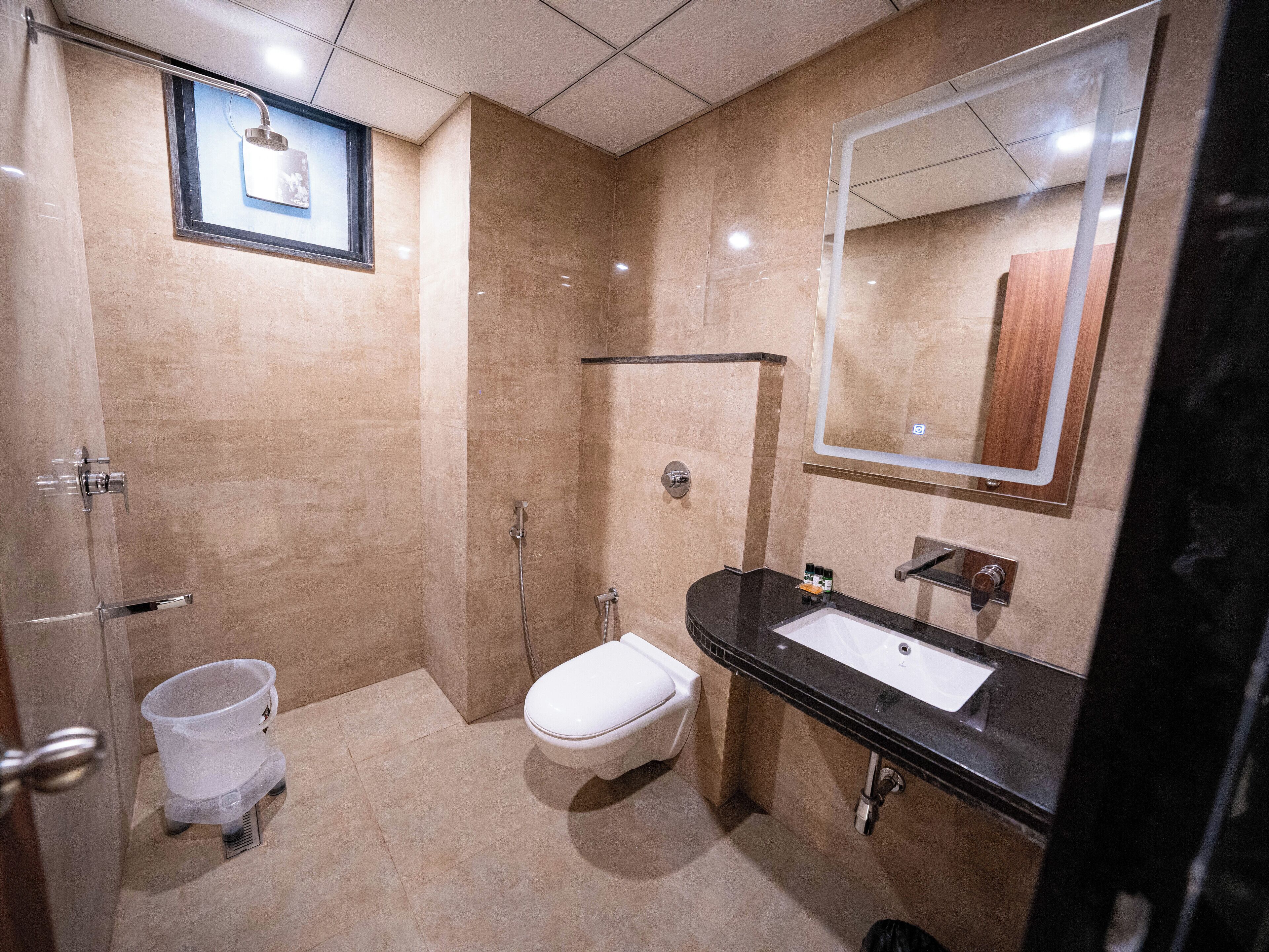 A modern bathroom with a shower, toilet, and sink.