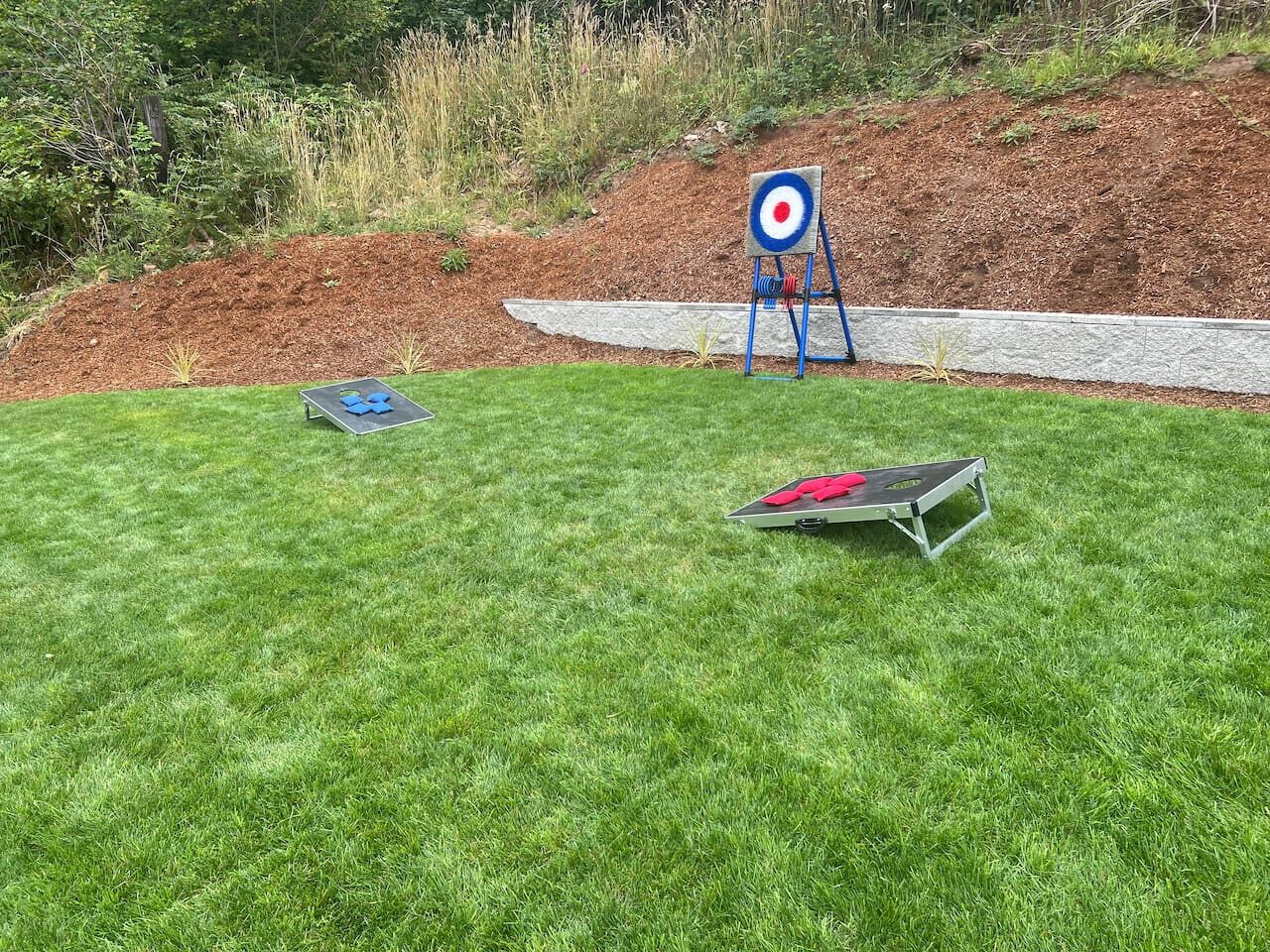 A grassy outdoor area with a target and two metal boards.