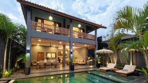 A two-story building with a pool, outdoor seating, and a balcony. - Villa Alami by Villa Finder (Seminyak)