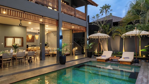 A two-story building with a pool area, outdoor seating, and a staircase leading to the upper level. - Villa Alami by Villa Finder (Seminyak)