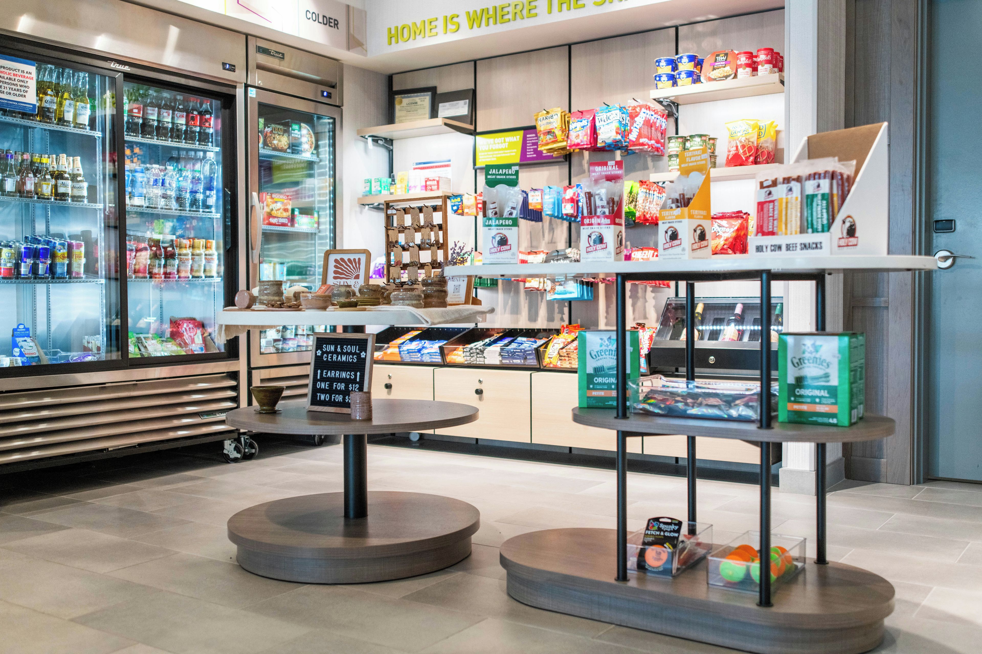 A grocery store with refrigerated sections, snack aisles, and a coffee station.