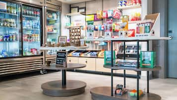 A grocery store with refrigerated sections, snack aisles, and a coffee station.