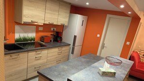 Una cocina moderna con armarios de madera, horno empotrado y refrigerador.