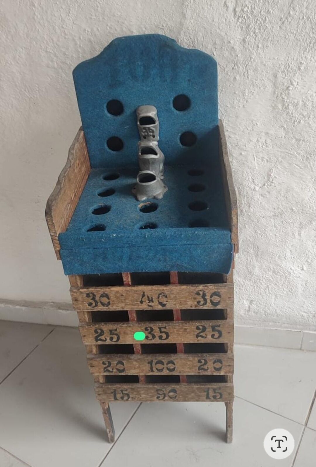 A wooden chest with a blue top and numbered compartments.