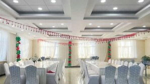 A conference room with white tables and chairs, decorated with red and green balloons. - Hailar Dongsheng Luxury Hotel (Hailar Airport Branch) (Hulunbuir)