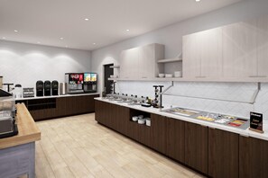 A modern kitchen with a long counter, built-in appliances, and a coffee machine. - Staybridge Suites Port Arthur Mall Area (Port Arthur)