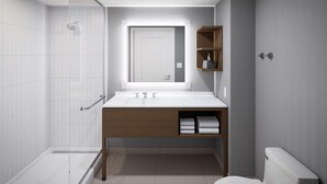 A modern bathroom with a glass shower enclosure, a white sink with a wooden vanity, and a toilet.