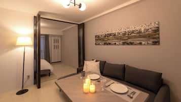 Deluxe Apartment | Living area | 32-inch flat-screen TV with digital channels