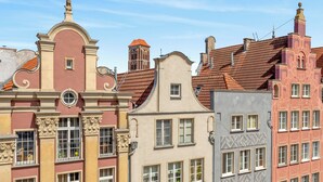 A row of historic buildings with distinct architectural styles, including ornate facades and traditional roofing.