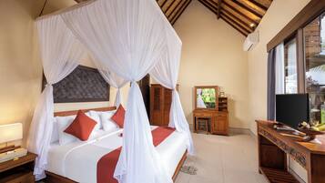 A bedroom with a four-poster bed, a wooden nightstand, a dresser, and a television.