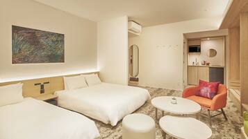 A hotel room with two beds, a small table, a chair, a mirror, and a painting on the wall.