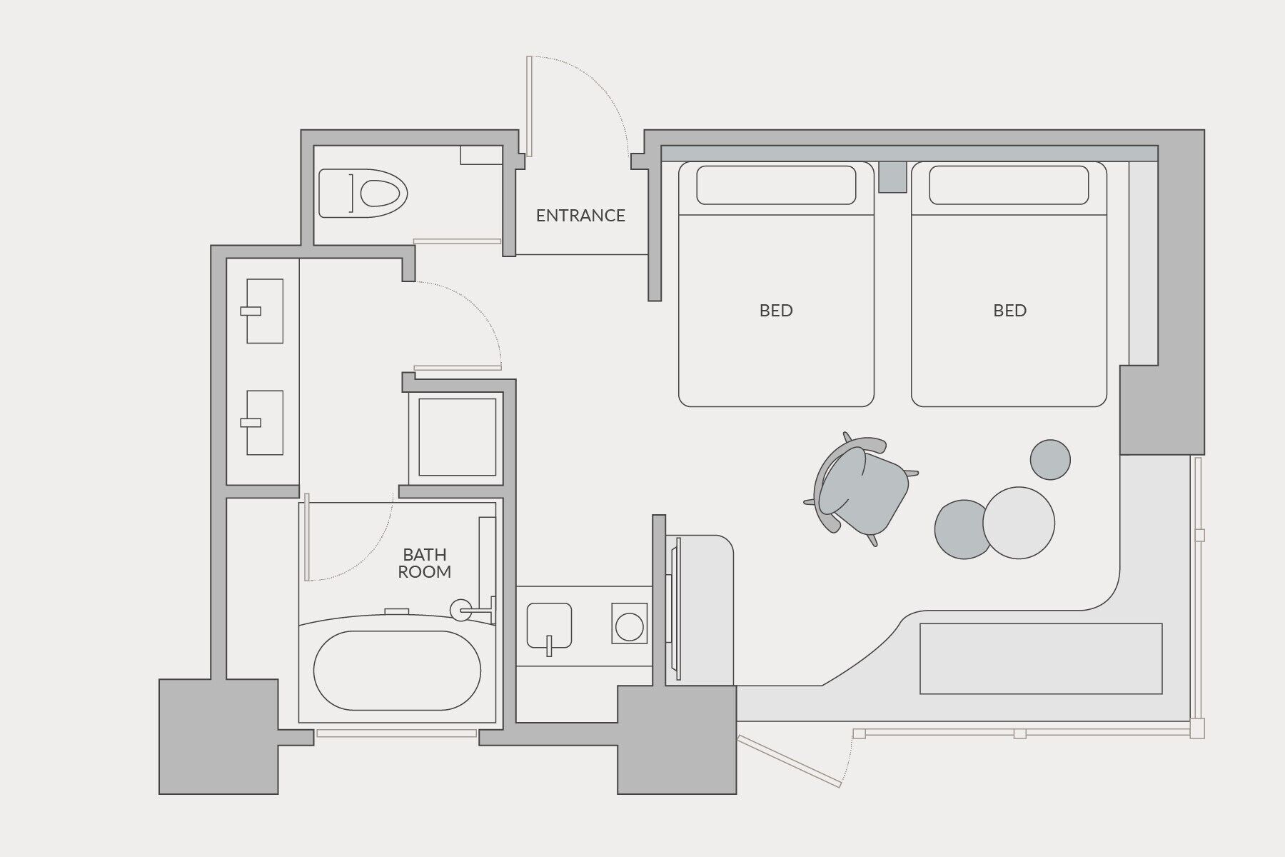 A floor plan with two bedrooms, a bathroom, a kitchen, and a living area.