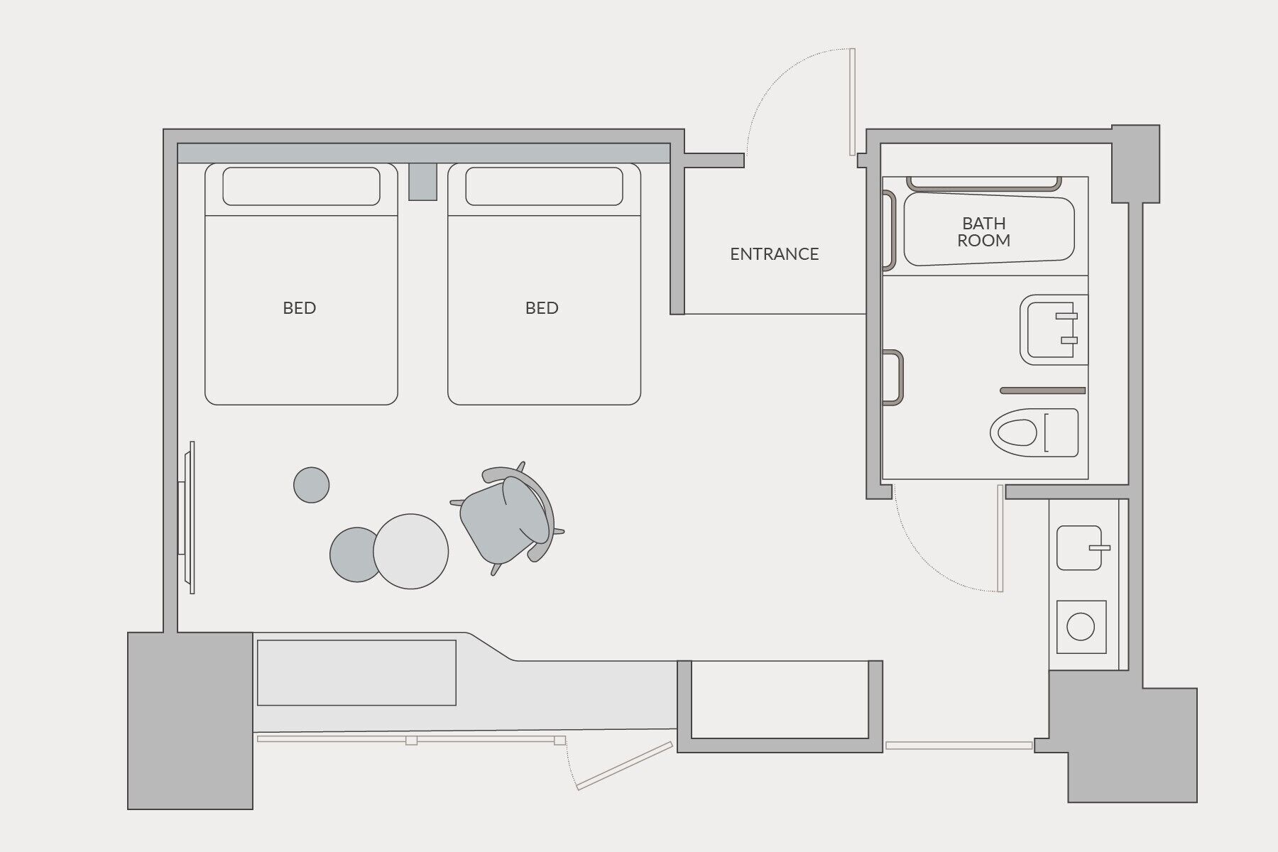 A floor plan of a hotel room with two beds, a bathroom, a small kitchen, and a seating area with a table and chairs.