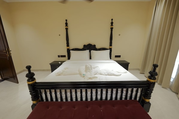 A neatly made bed with white linens and a red upholstered headboard. - Shree Raja Ram Hotel & Resort (Ujjain)