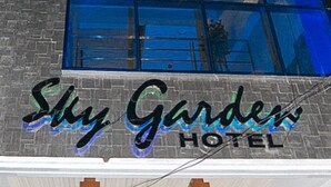 The exterior of Sky Garden Hotel with a prominent sign and a brick facade. - Sky Garden Hotel By Reddoorz (Roxas City)
