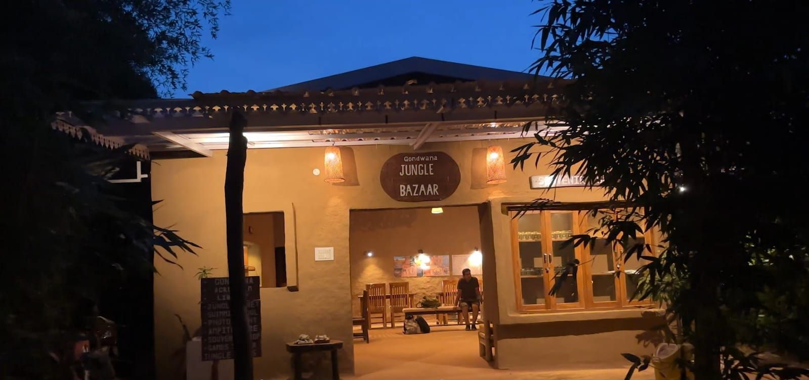 A building with a sign reading "Jungle Bazaar" and a sign below it stating "Shop At Jungle B".