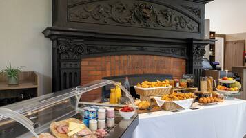 A breakfast buffet with various food items and beverages.