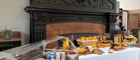 A breakfast buffet with various food items and beverages.