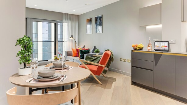 A modern living room with a dining area, a kitchen, and a large window. - ShyPen One - Bedroom APT (London)