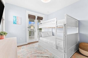 A bunk bed room with a view of a balcony and a door leading outside. - NEW! LSV/golf cart & Bikes Included! Resort-Style Pool in Highland Parks! (Santa Rosa Beach)